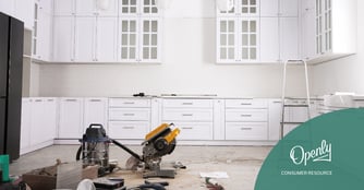 A white kitchen undergoing a remodel with tools in the foreground.