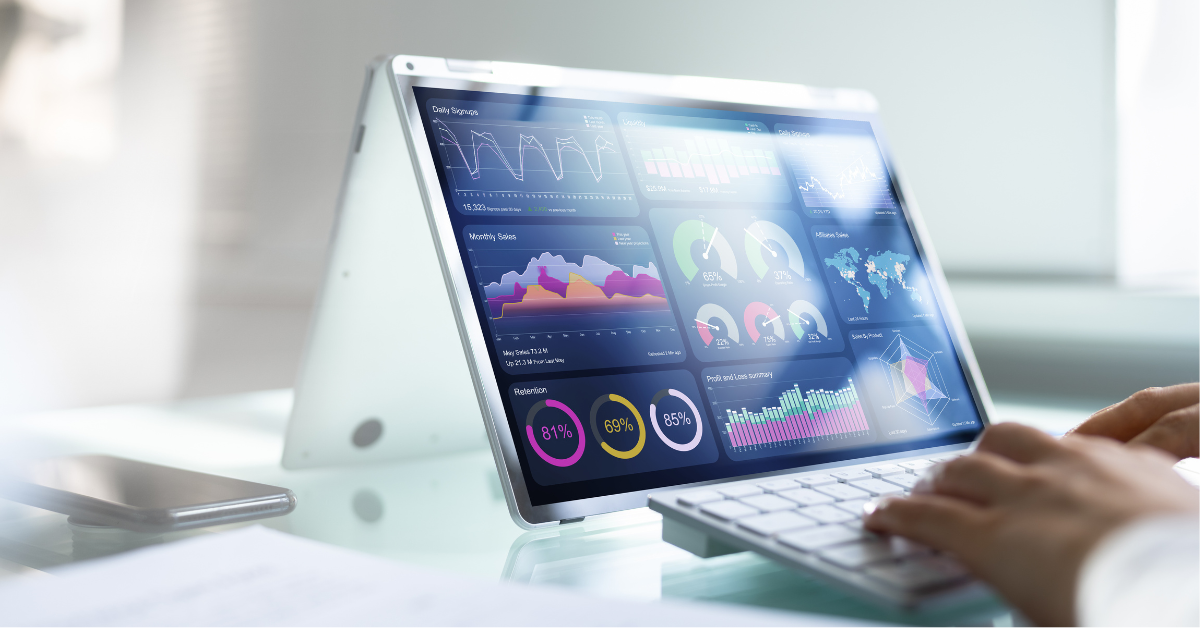 A person types on a tablet keyboard while a number of graphs and charts show on the tablet screen. 
