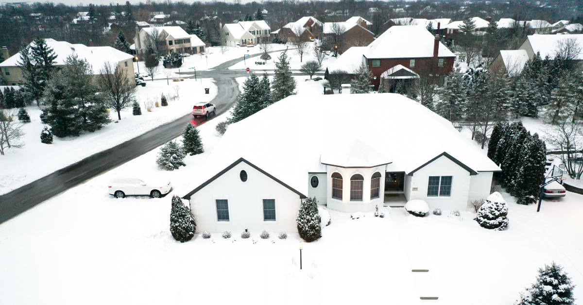 A midwestern neighborhood covered in snow. 
