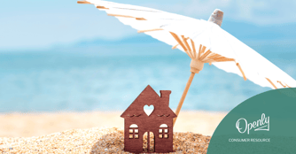 An umbrella shades a wooden house on the beach. 