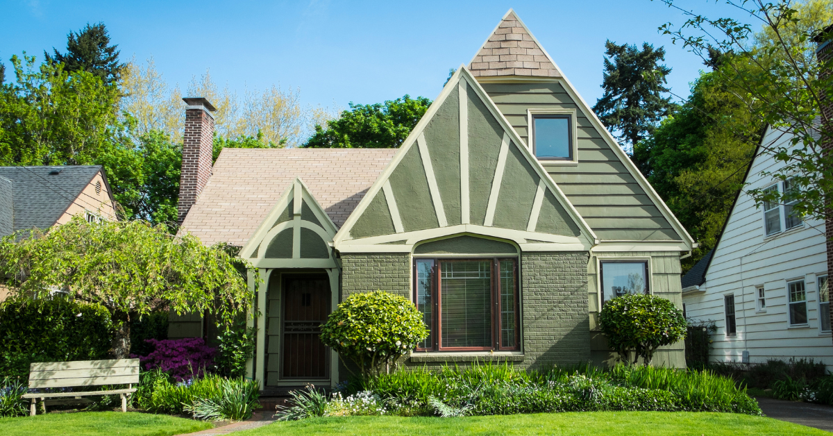 A green craftsman style house.